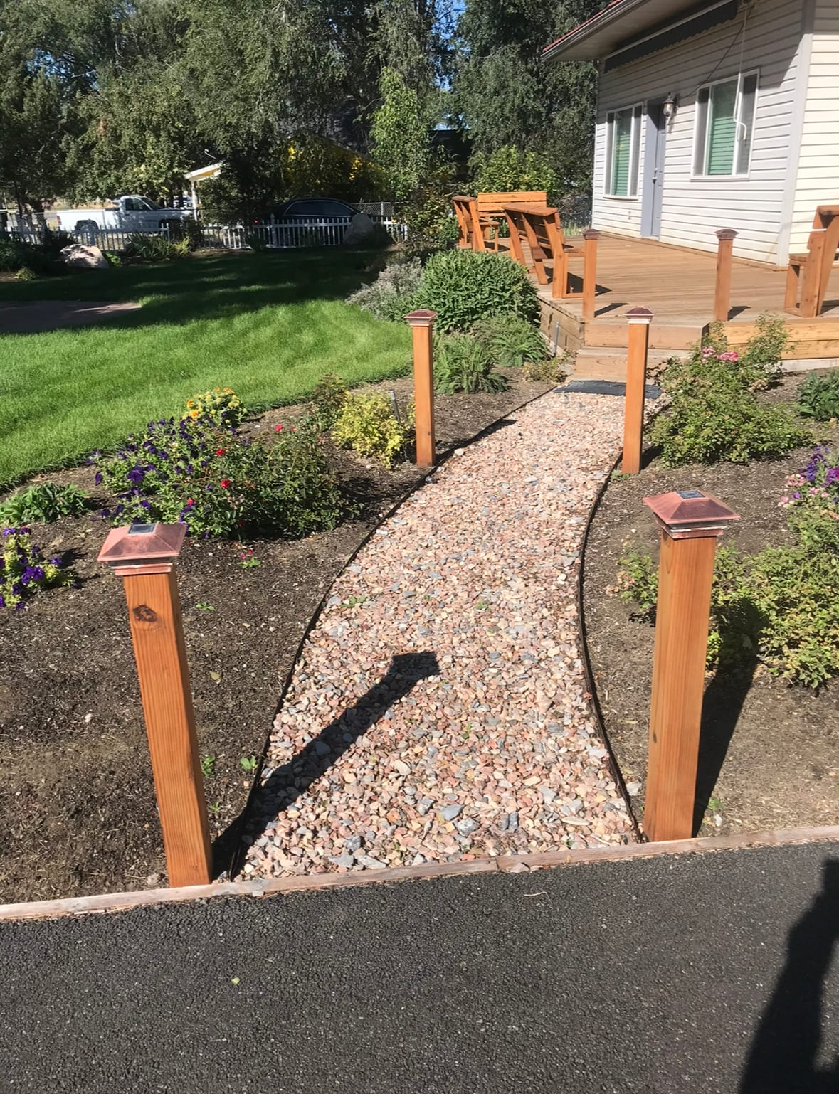 Decorative gravel walkway and planned planting beds for landscape design in Davis County